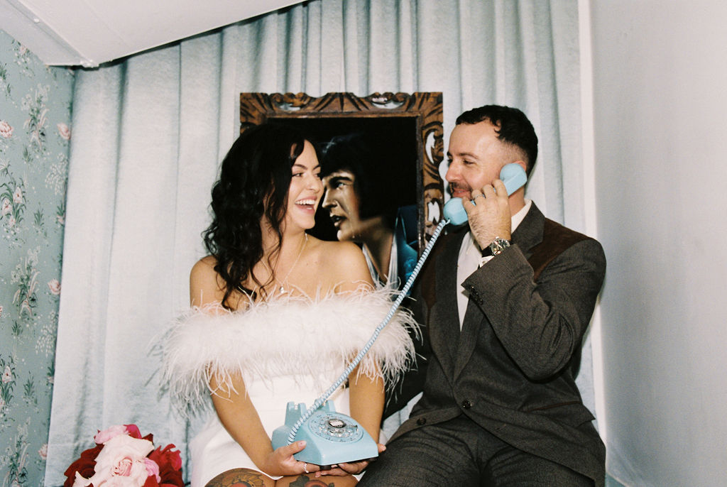 Couple celebrating their sure thing chapel elopement in Las Vegas surrounded by joyful guests.
