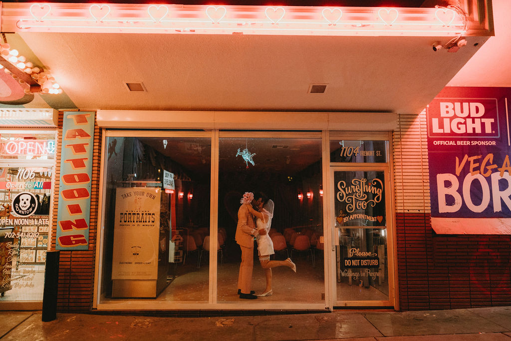 Newly married couple celebrating their Sure Thing Too elopement in downtown Las Vegas.