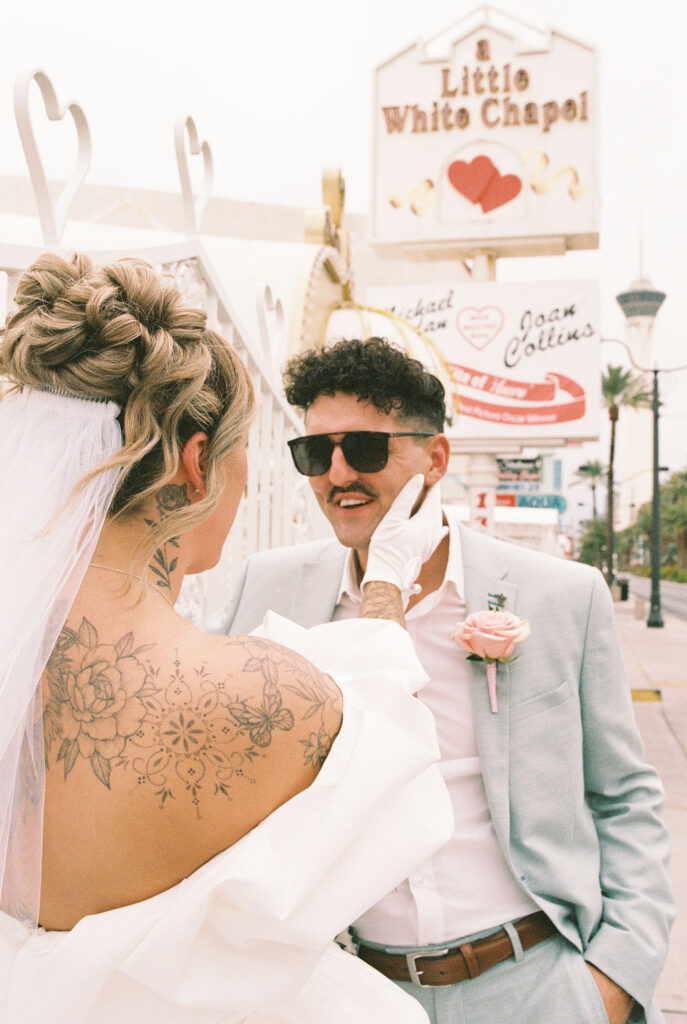 Candid moment of the couple celebrating their downtown Las Vegas wedding with playful energy.
