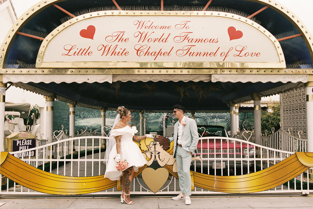 Candid moment of the couple celebrating their downtown Las Vegas wedding with playful energy.
