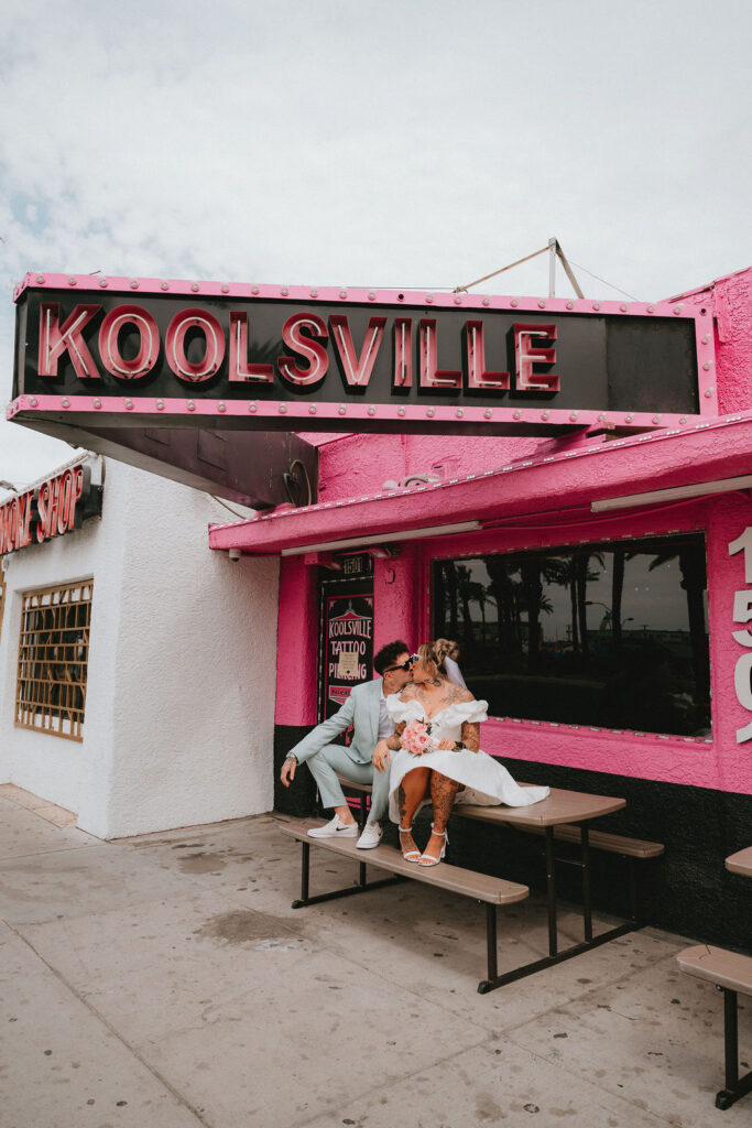 Candid moment of the couple celebrating their downtown Las Vegas wedding with playful energy.
