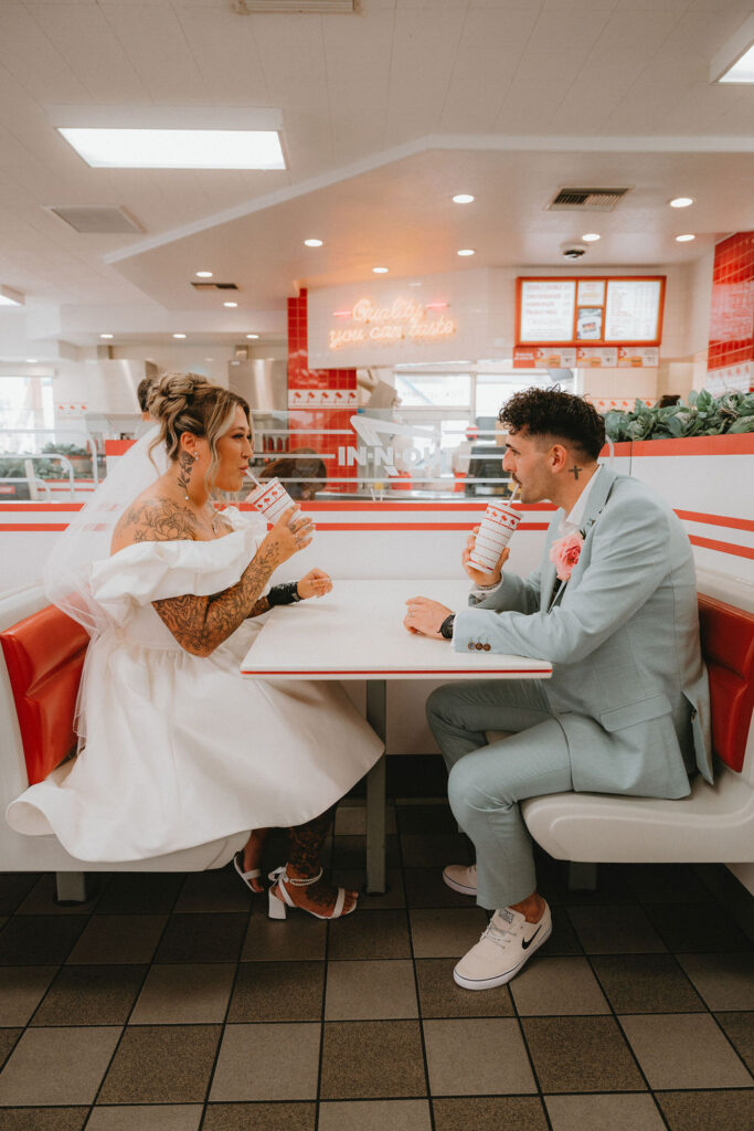 Candid moment of the couple celebrating their downtown Las Vegas wedding with playful energy.
