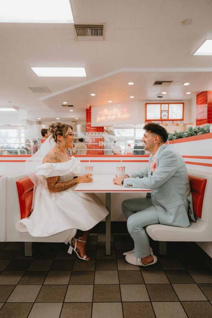 Candid moment of the couple celebrating their downtown Las Vegas wedding with playful energy.
