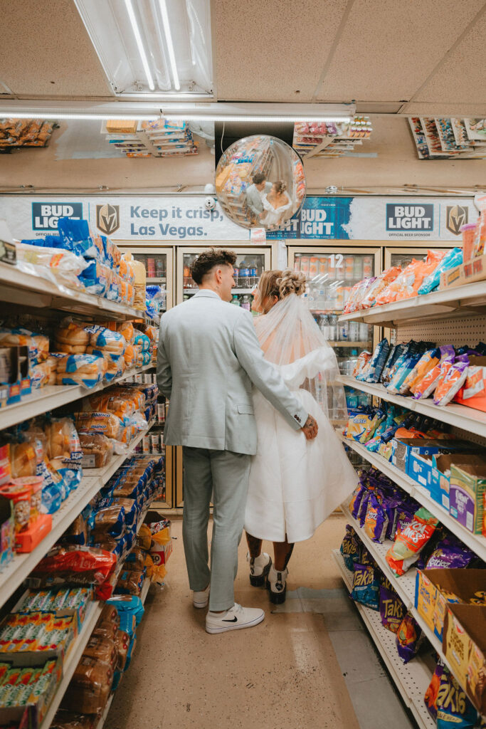 Wedding portraits in the heart of downtown Las Vegas with neon lights glowing behind the couple.
