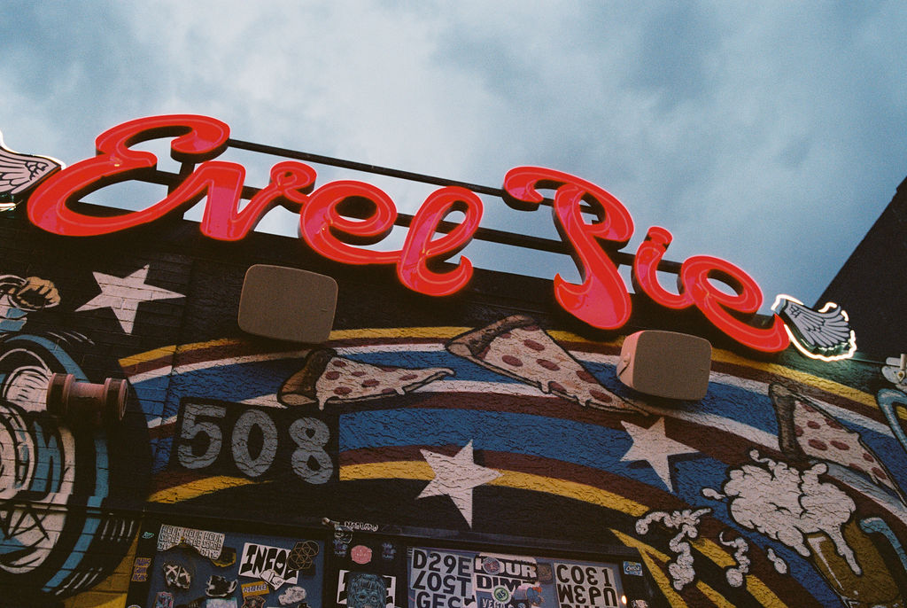 Wedding portraits in the heart of downtown Las Vegas with neon lights glowing behind the couple.
