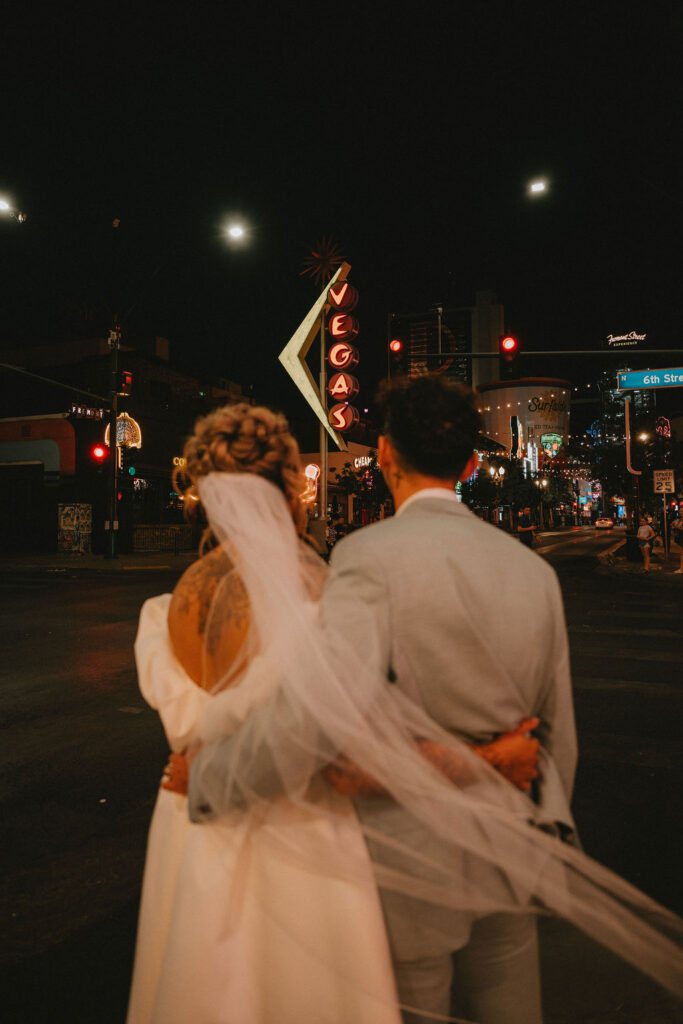 Couple exploring downtown Las Vegas during their wedding day with a fun and candid vibe.
