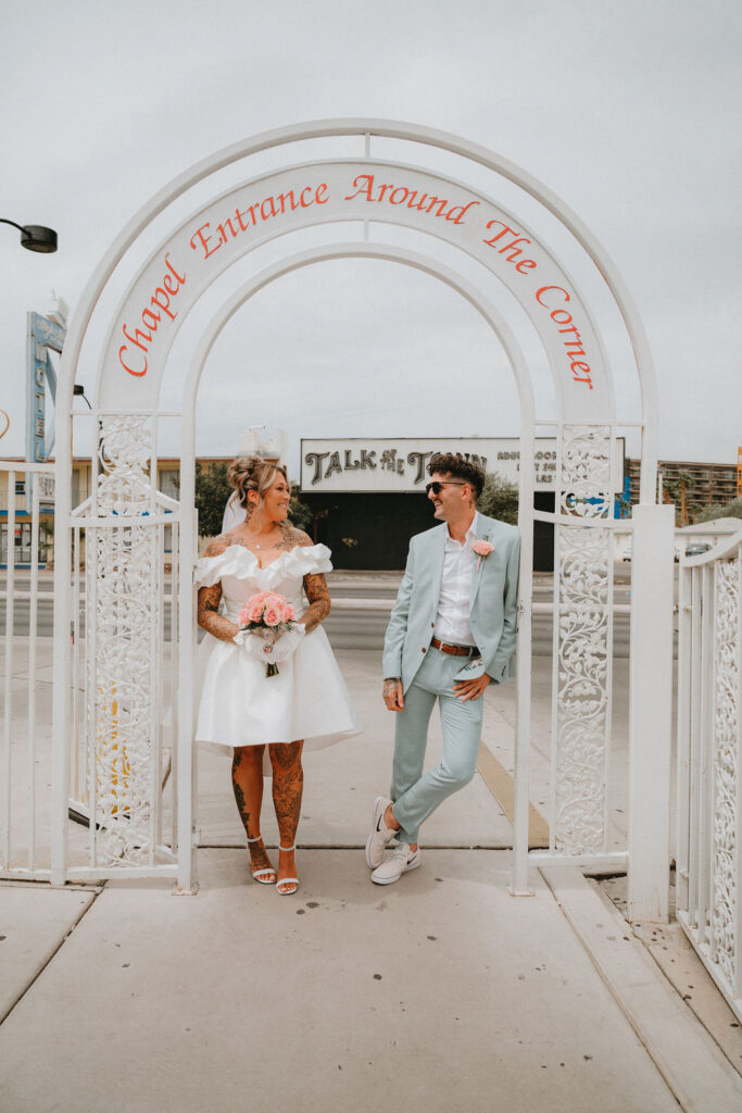 Candid moment of the couple celebrating their downtown Las Vegas wedding with playful energy.
