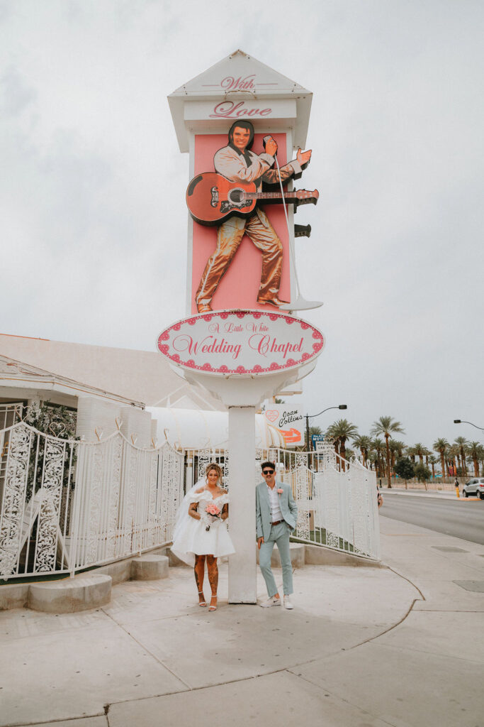 Candid moment of the couple celebrating their downtown Las Vegas wedding with playful energy.
