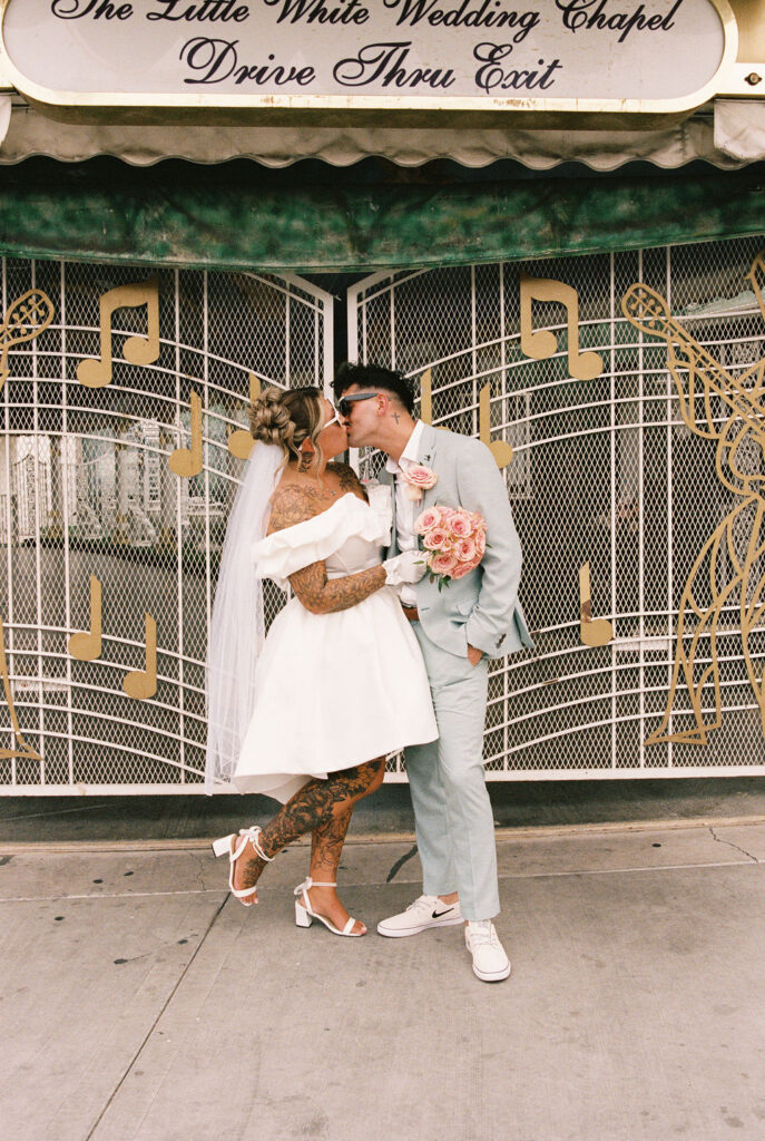 Wedding portraits in the heart of downtown Las Vegas with neon lights glowing behind the couple.
