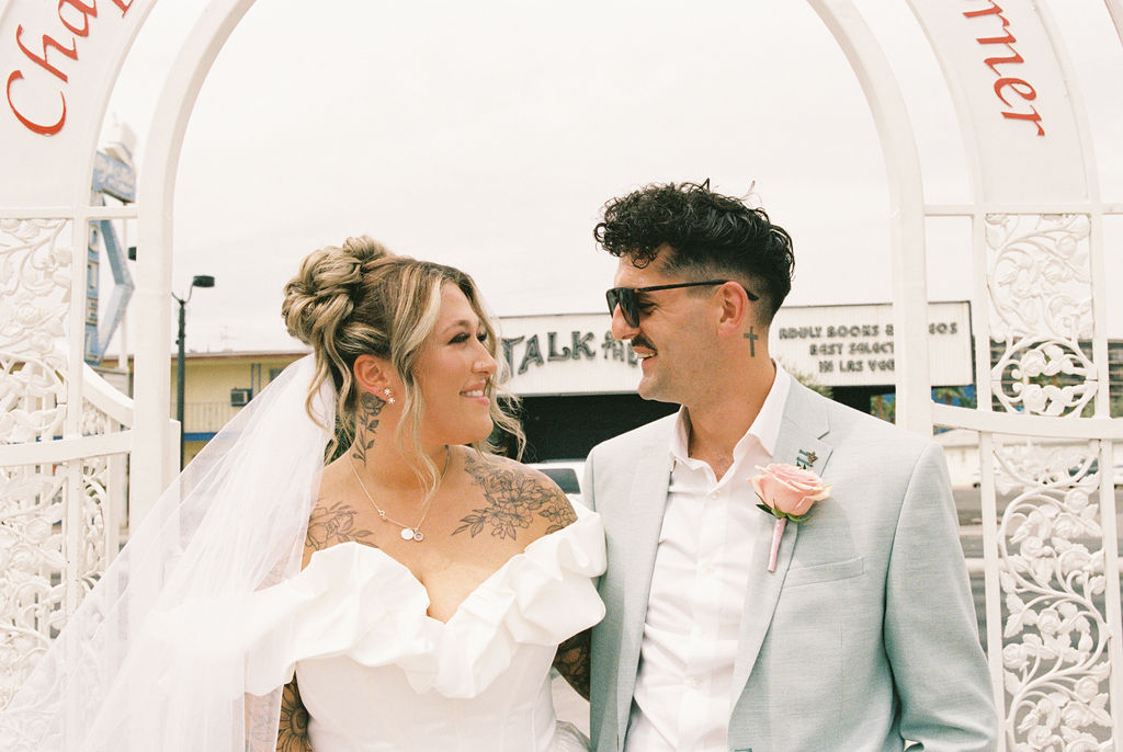 Wedding portraits in the heart of downtown Las Vegas with neon lights glowing behind the couple.
