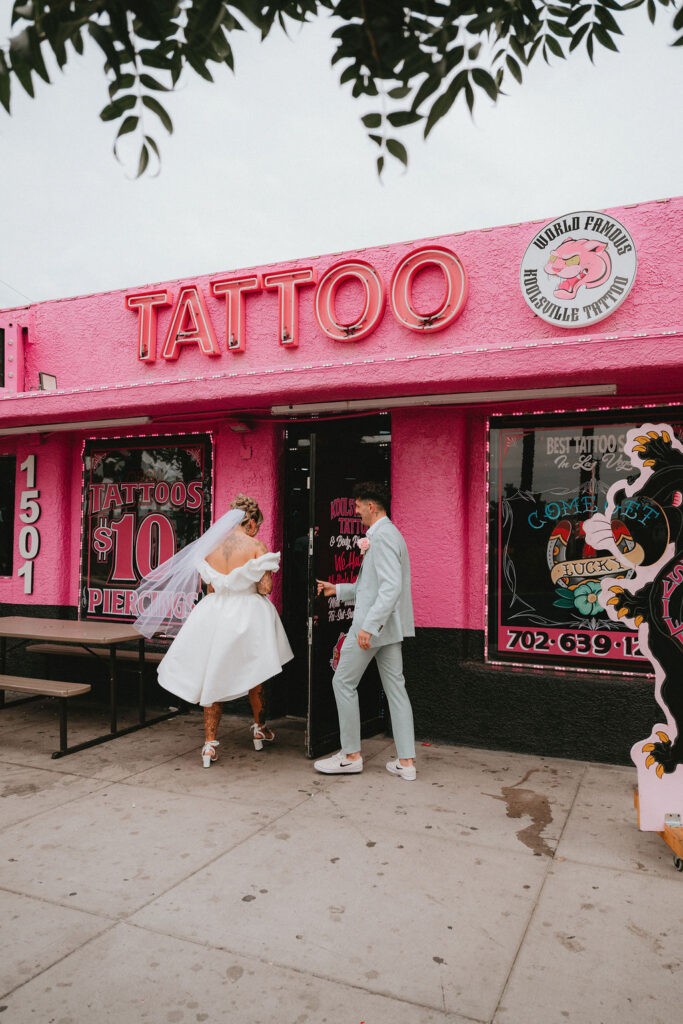 Candid moment of the couple celebrating their downtown Las Vegas wedding with playful energy.