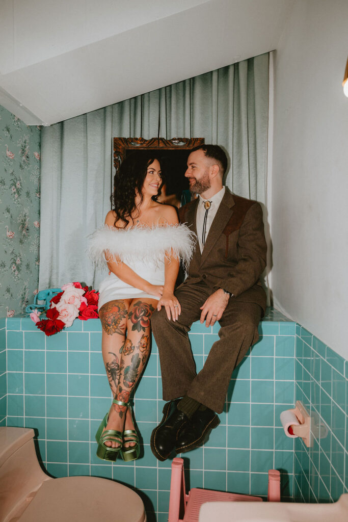 Couple celebrating their sure thing chapel elopement in Las Vegas surrounded by joyful guests.
