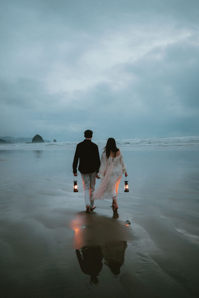 Couple walking along the Oregon Coast during a moody engagement session.