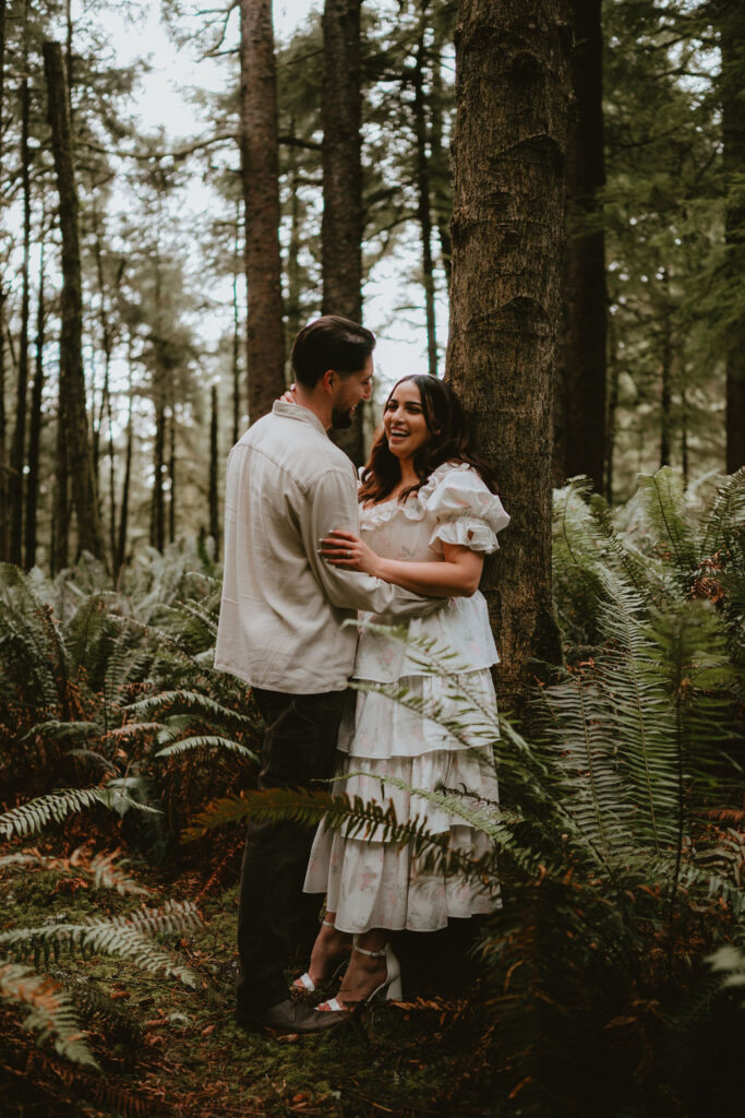 Couple walking along the Oregon Coast during a moody engagement session.