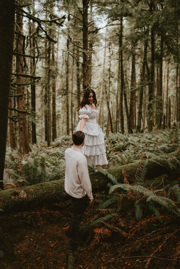 Couple walking along the Oregon Coast during a moody engagement session.