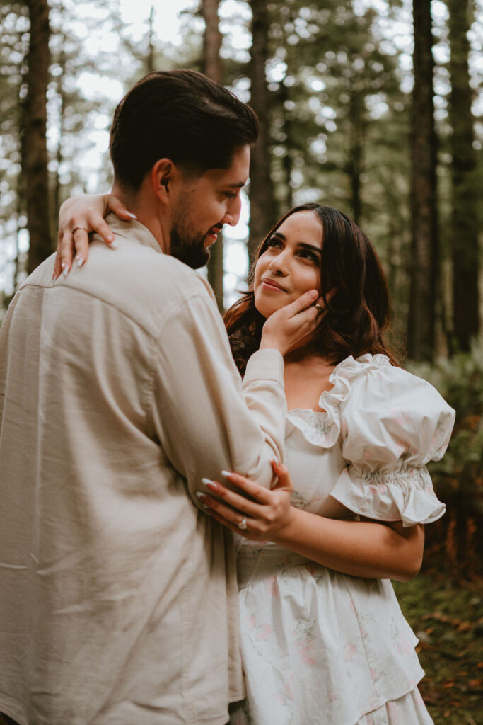Couple walking along the Oregon Coast during a moody engagement session.