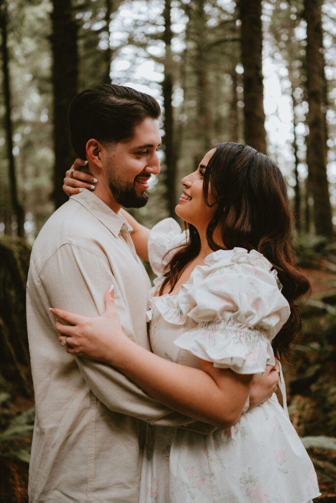 Couple walking along the Oregon Coast during a moody engagement session.