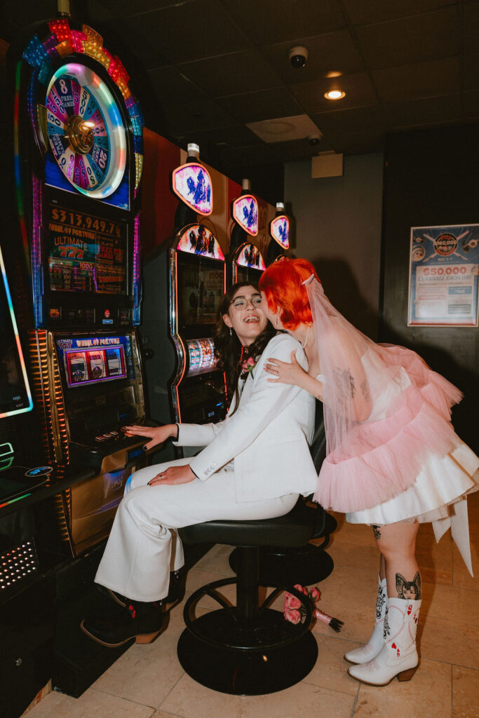 Zoe and Parker celebrating in downtown Las Vegas with neon lights glowing behind them.
