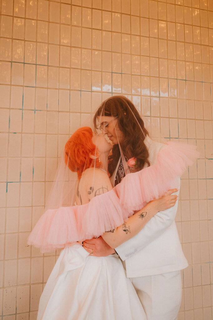 Zoe and Parker celebrating in downtown Las Vegas with neon lights glowing behind them.