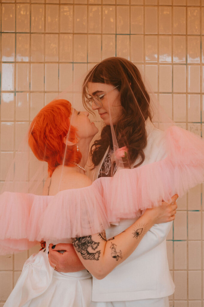 Zoe and Parker celebrating in downtown Las Vegas with neon lights glowing behind them.
