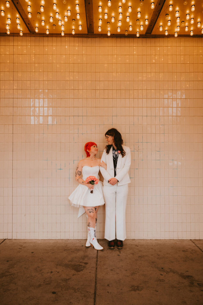 Zoe and Parker celebrating in downtown Las Vegas with neon lights glowing behind them.