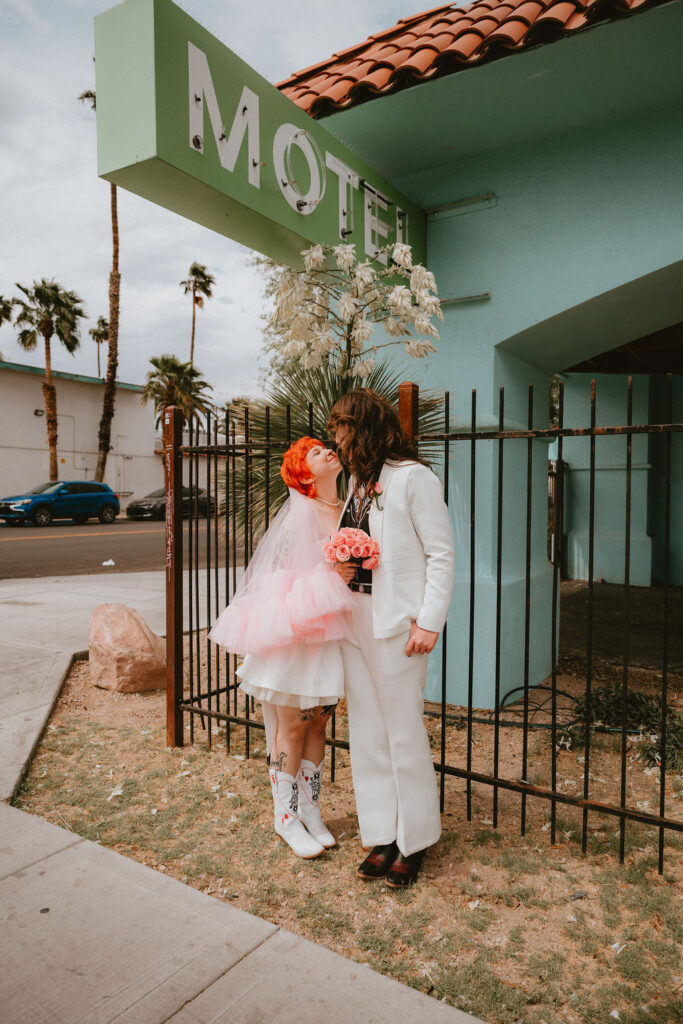 Zoe and Parker celebrating in downtown Las Vegas with neon lights glowing behind them.
