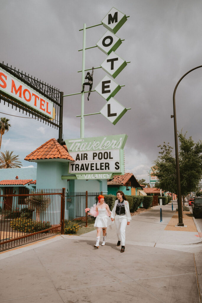 Zoe and Parker celebrating in downtown Las Vegas with neon lights glowing behind them.