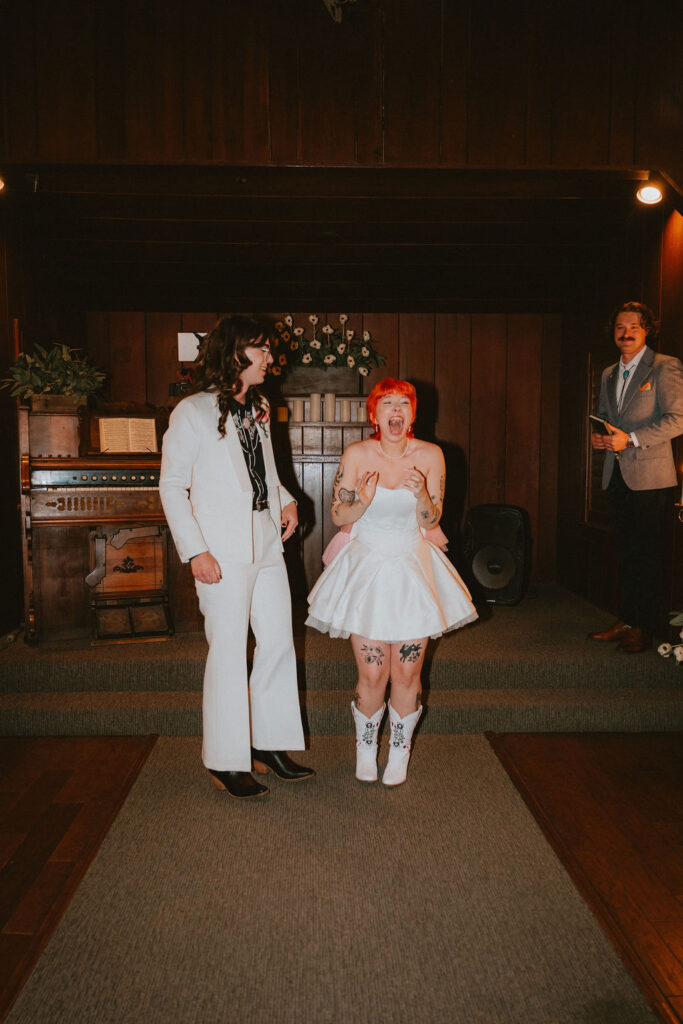 Candid photo of the couple holding hands after their ceremony at Little Church of the West.
