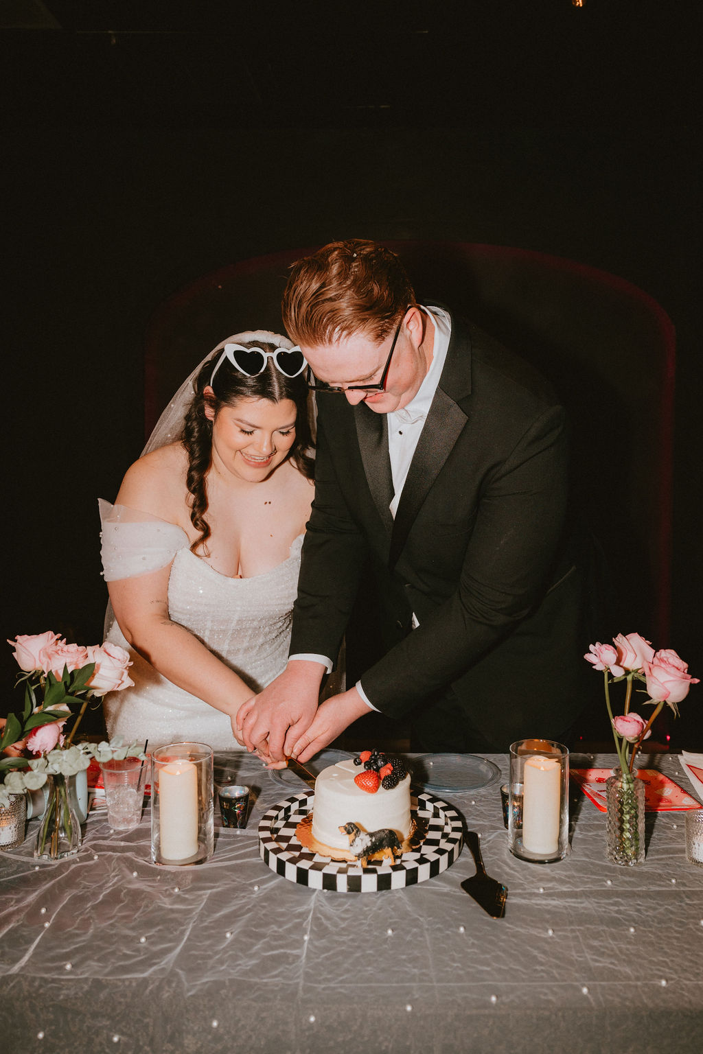 Bride and groom cutting cake at their Las Vegas wedding reception