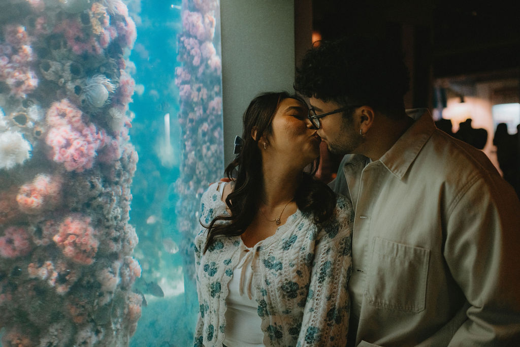 Couple kisses during cinematic engagement photoshoot