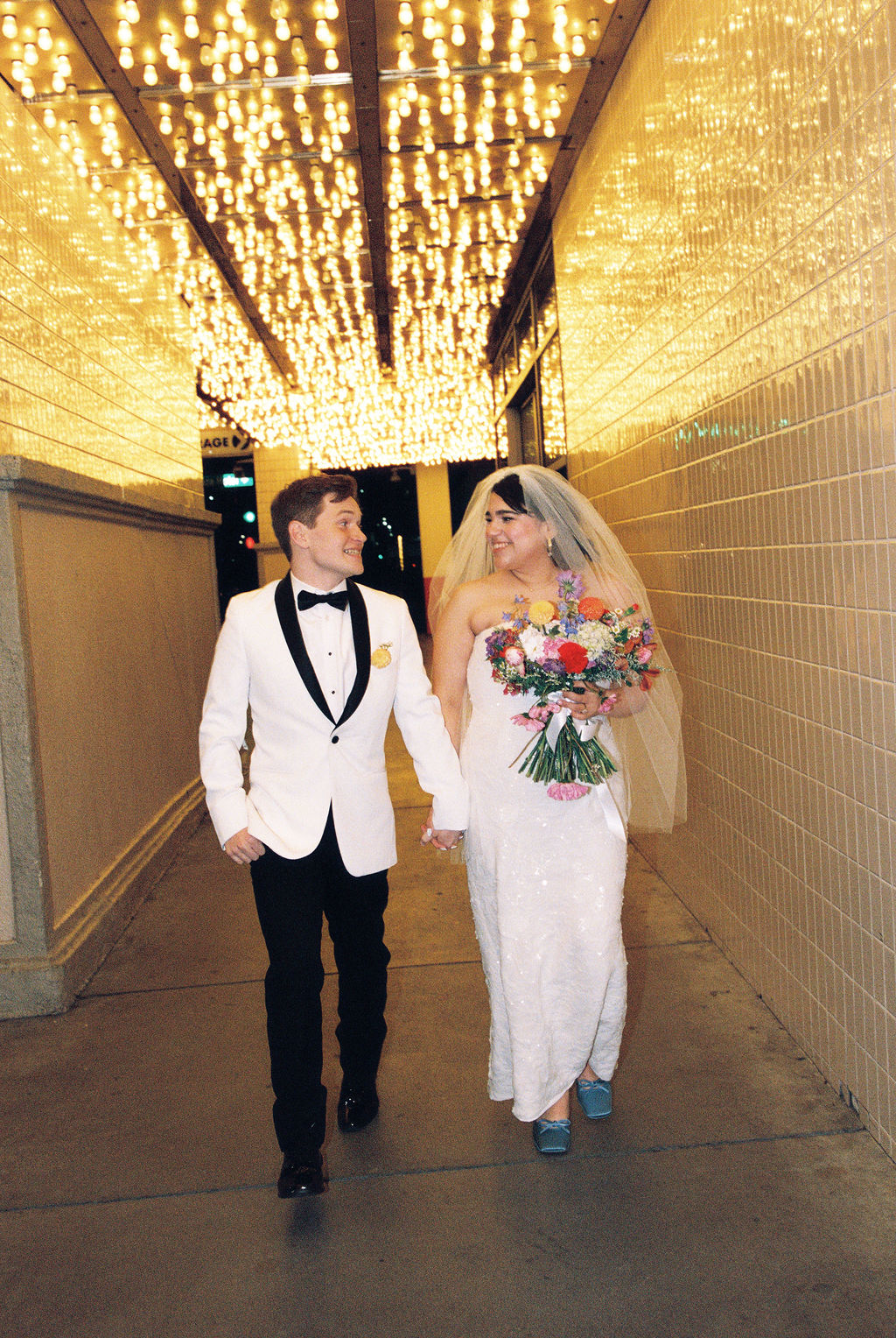 Couple walks holding hands at their playful Las Vegas elopement downtown