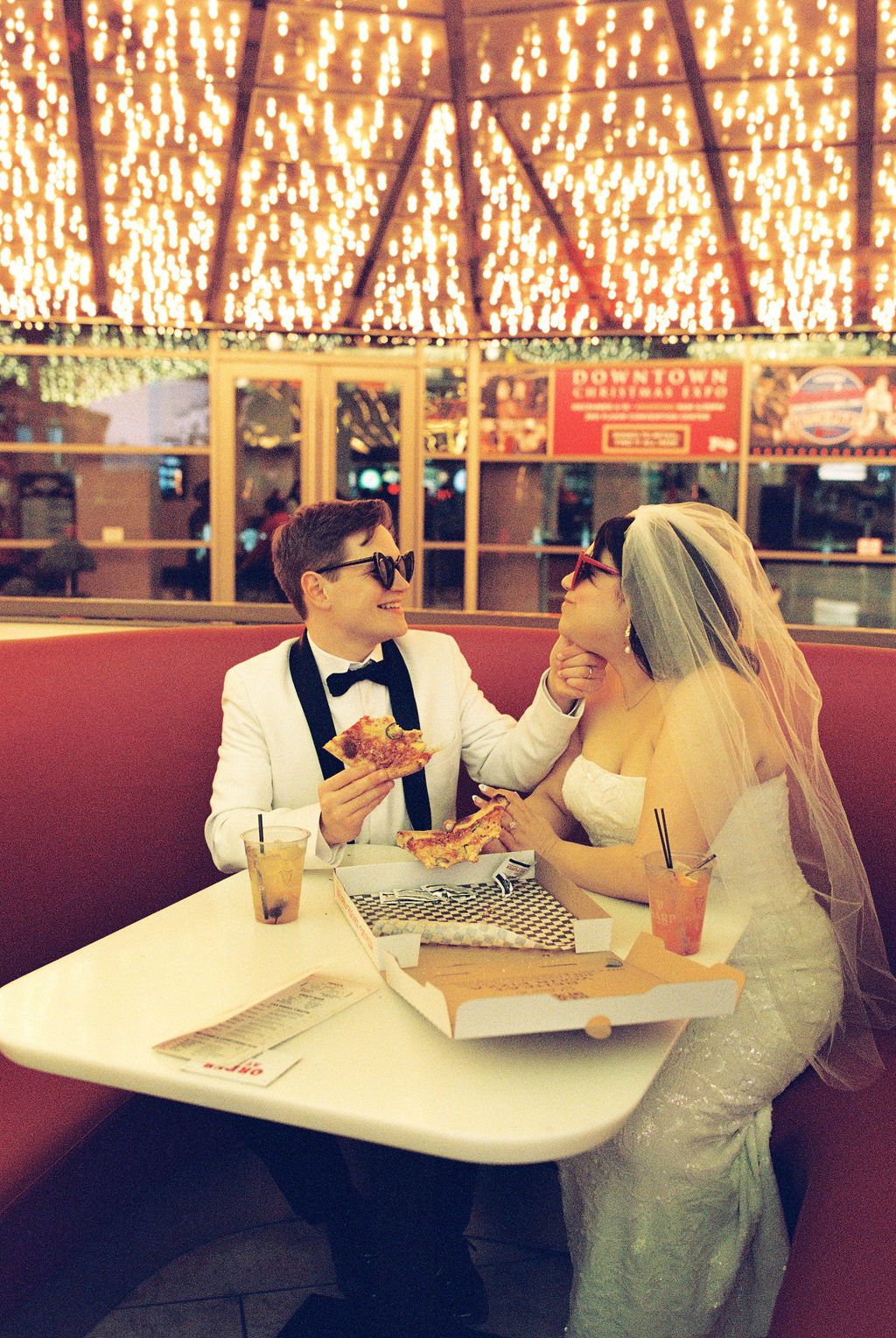 Film photo of couple eating pizza at their Las Vegas elopement
