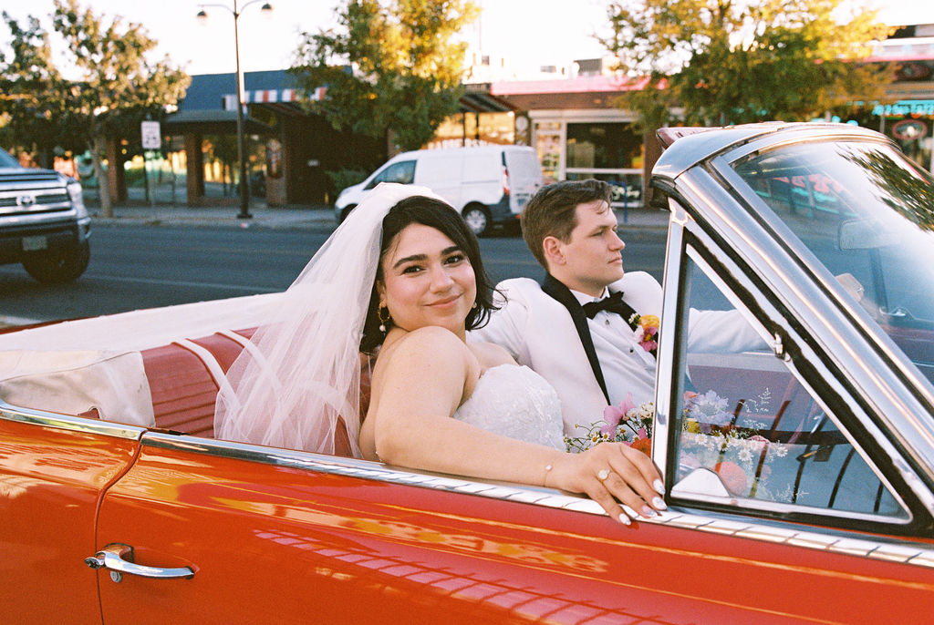Bride and groom in classic car at their Playful Las Vegas elopement