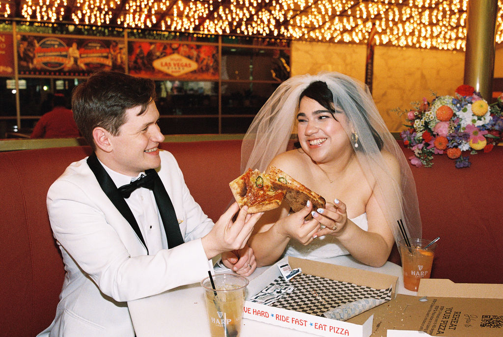 Couple eating pizza at their Las Vegas elopement
