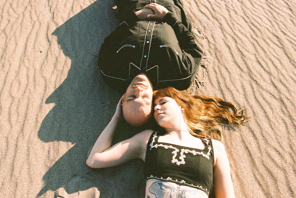 Couple laying in the sand at Amargosa Valley
