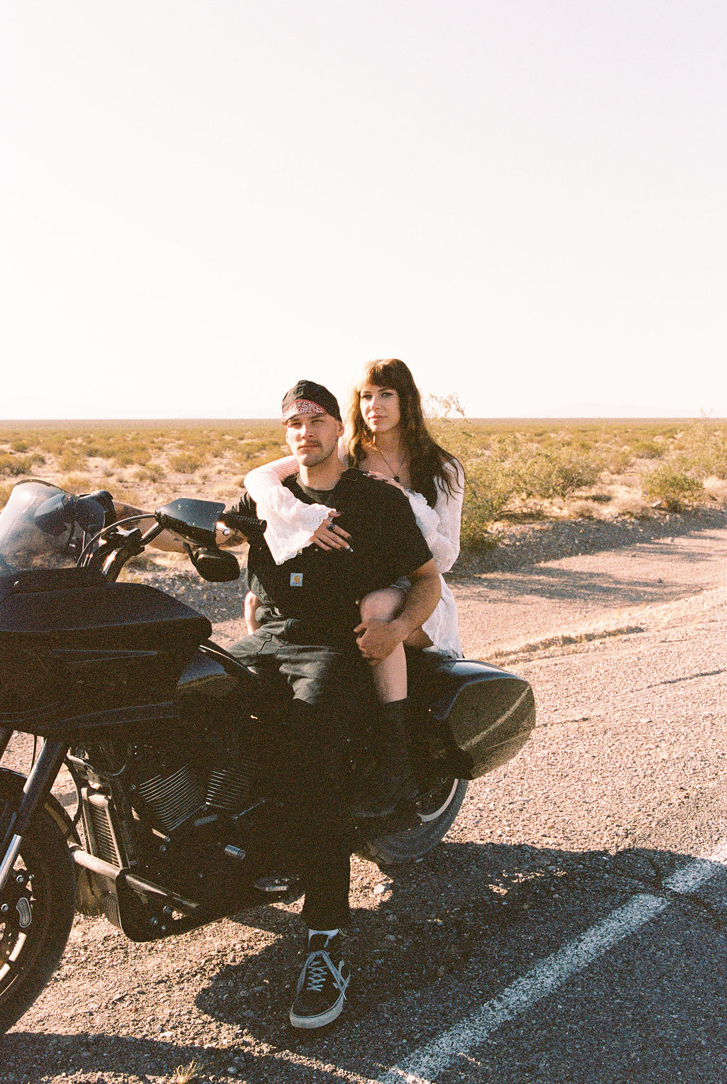 Man and woman on a motorcycle during Amargosa Valley engagement photos