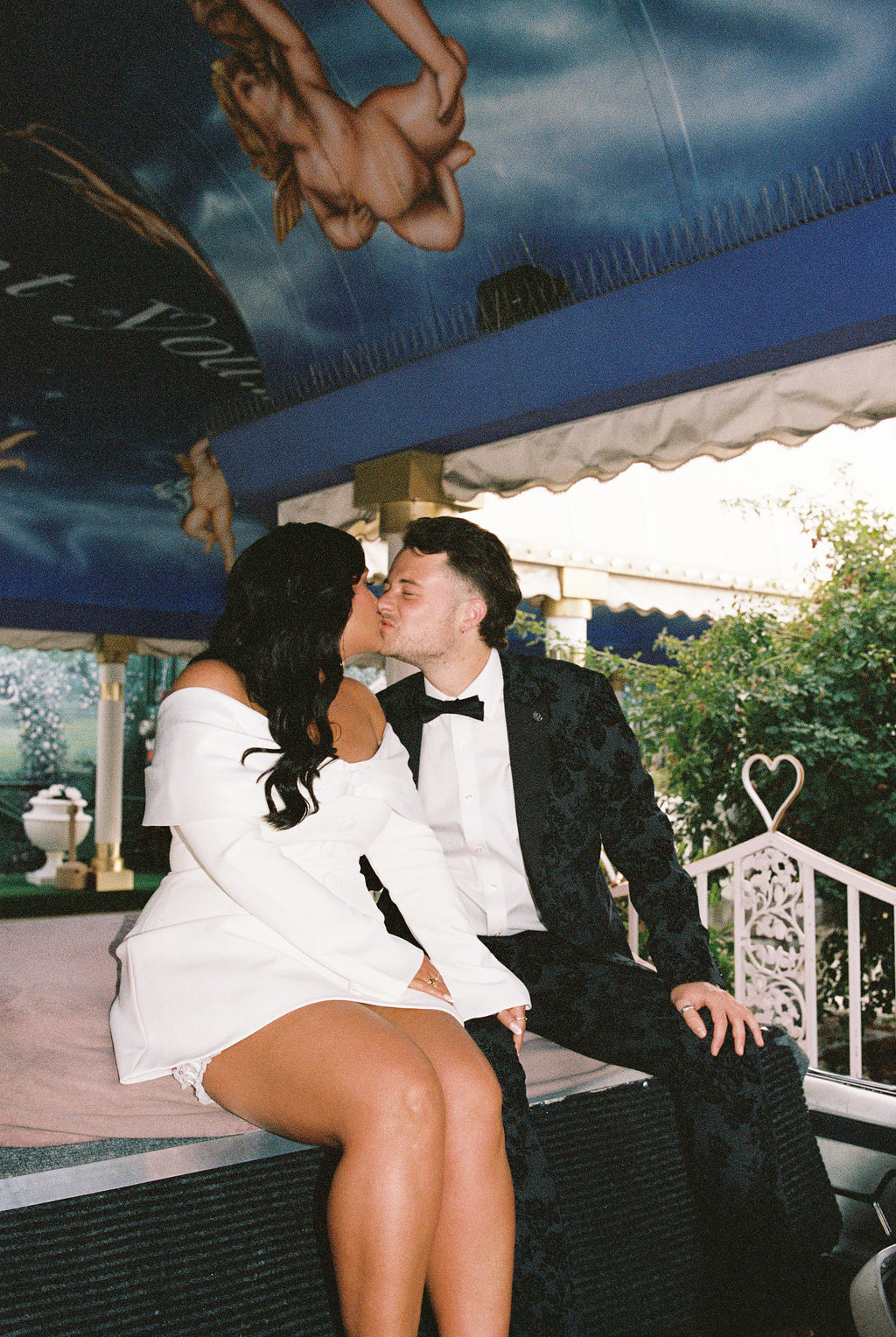 Bride and groom kiss at Tunnel of Love wedding ceremony
