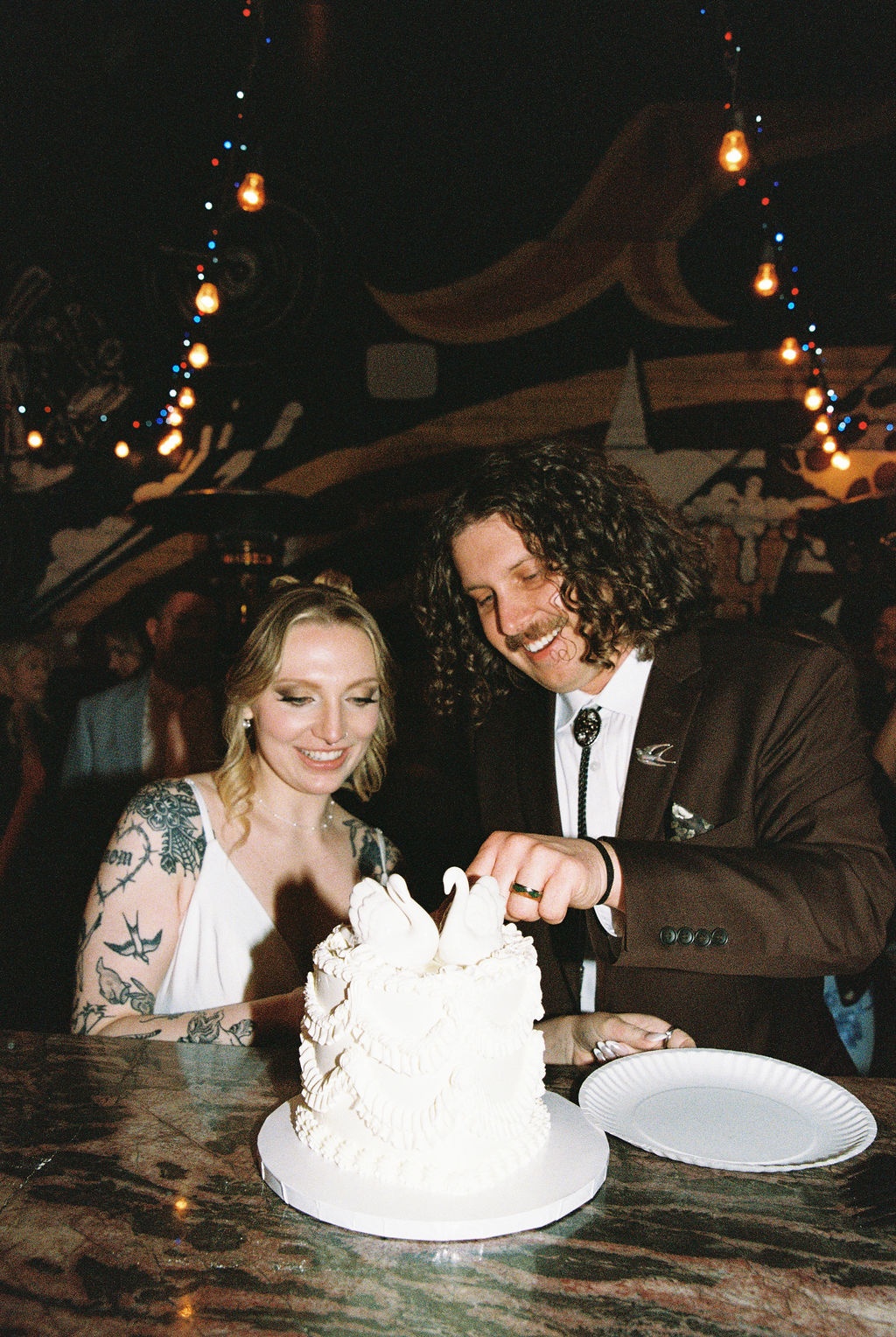 Bride and groom cut wedding cake at Evel Pie Vegas