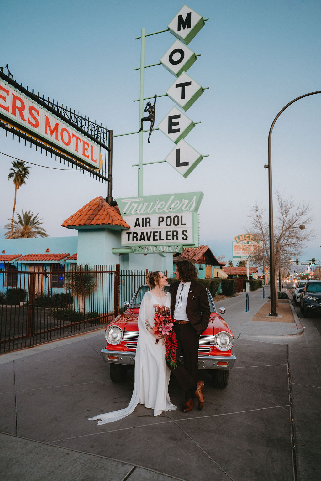 Bride and groom in front of a vintage car in Vegas