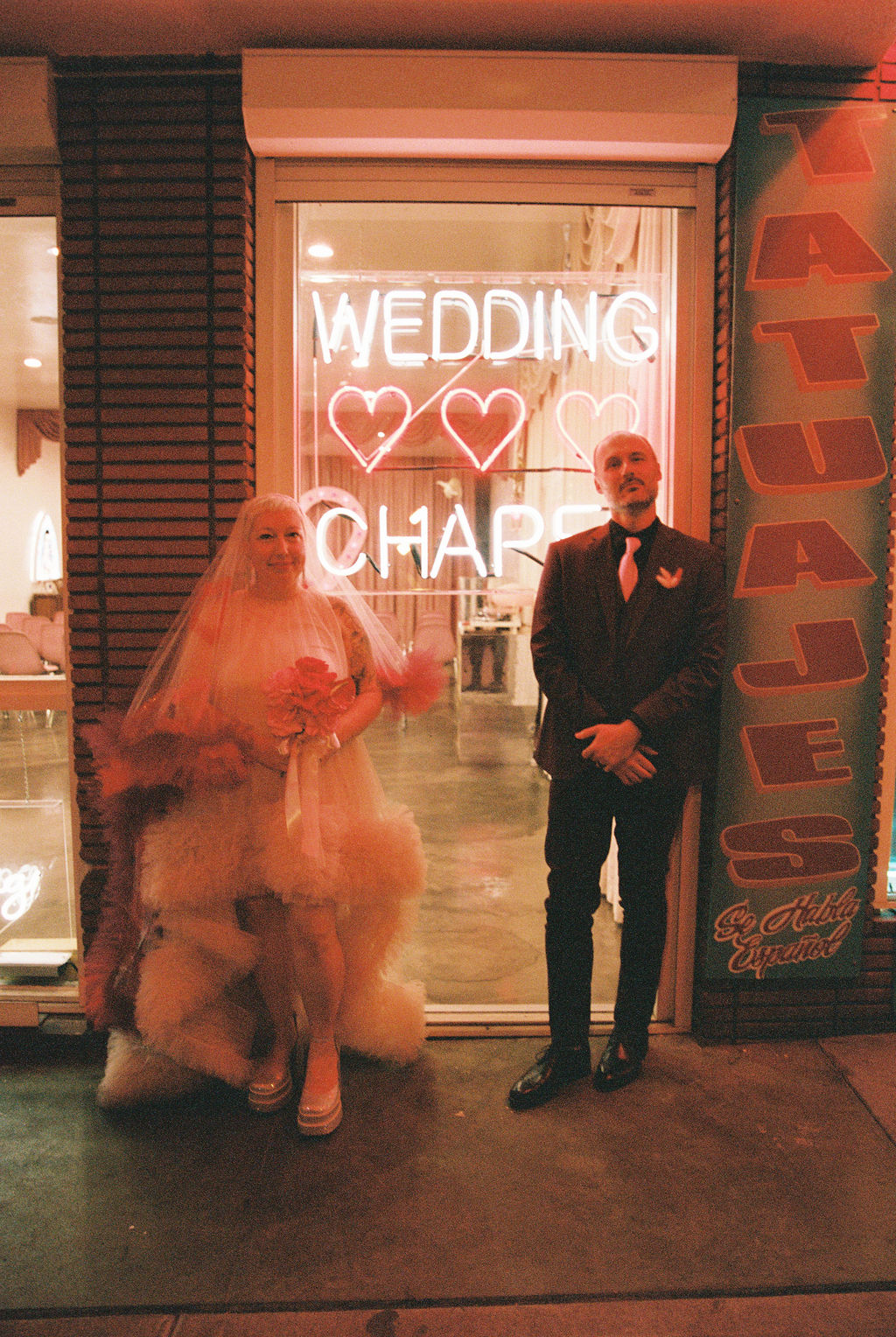 Couple outside of Sure Thing Chapel after their Hellvis wedding