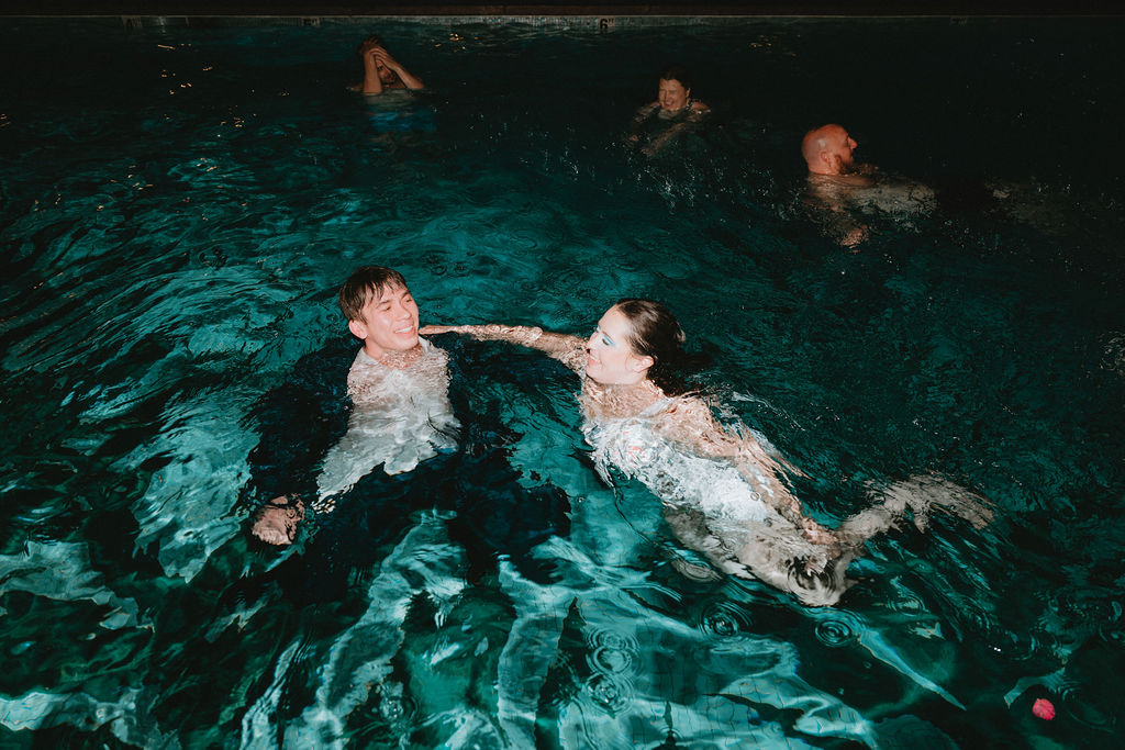 Bride and groom in the pool at their Oasis at Death Valley wedding